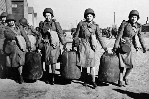 Women help each other with bags at an embarkation port in the U.S. in this Jan. 29, 1943, photo provided by the U.S. Army. They were bound for North Africa with the first detachment of the Women's Auxiliary Army Corps to be sent abroad.